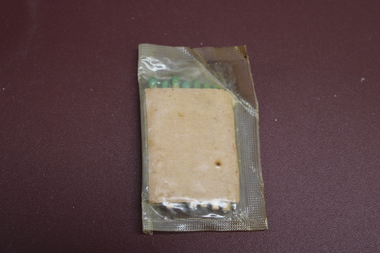 Sealed clear wrapper with seven green tipped matched contained in a brown cardboard cover.
