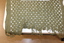 Open weaved, khaki army issue soft cotton material with frayed end.