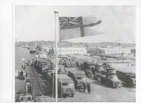 Black and white photograph of a loaded HMAS Sydney, September 1965 at the Brisbane wharf ready to sail to Vung Tau, Vietnam.