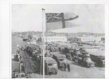 Black and white photograph of a loaded HMAS Sydney, September 1965 at the Brisbane wharf ready to sail to Vung Tau, Vietnam.