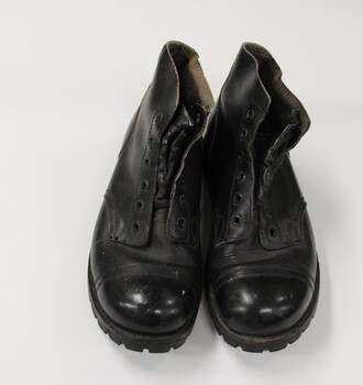 A pair of army issue black boots.