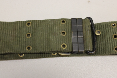 Khaki webbed belt with brass buckle, metal clamps and brass eyelets.