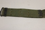 Khaki webbed belt with brass buckle, metal clamps and brass eyelets.