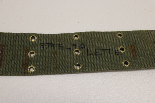 Khaki webbed belt with brass buckle, metal clamps and brass eyelets.