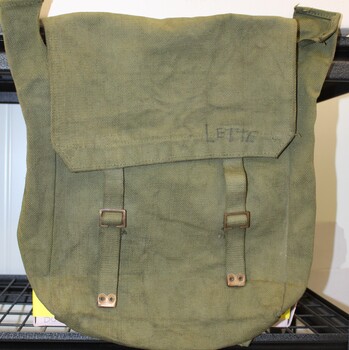 Army issue canvas pack with straps and buckles.  