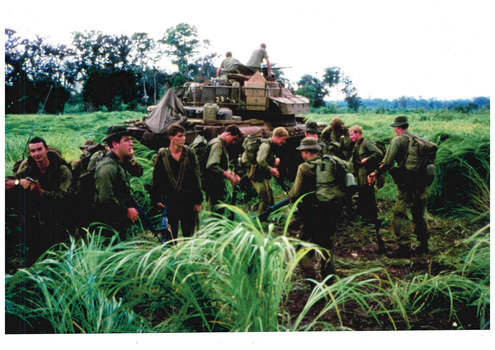 Coloured image of a jungle scene of soldiers fully equipment for combat.