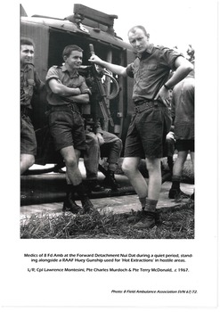 Medica of * Field Ambulance alongside RAAF Huey.