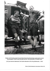 Medica of * Field Ambulance alongside RAAF Huey.