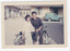 Small photo of two people on a scooter.