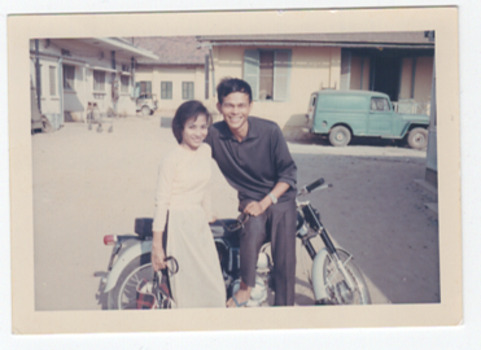 Small photo of two people on a scooter.
