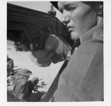 A Black and White Close Up Photograph of a Soldier Aiming his Gun