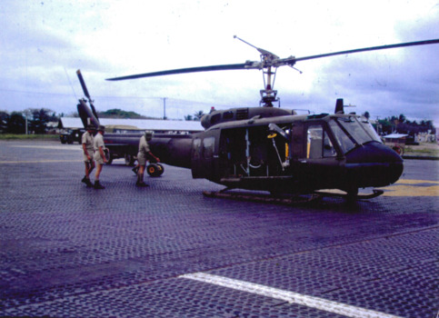 N.C.O's inspecting for tail boom damage after heavy landing.