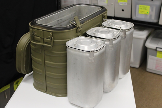Metal box with compartments used to keep food hot.