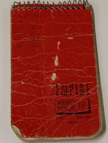 Small metal spiral bound booklet with red cover.