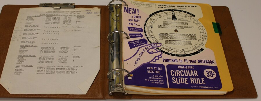 Brown plastic folder three ring binder for training notes.
