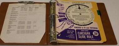 Brown plastic folder three ring binder for training notes.