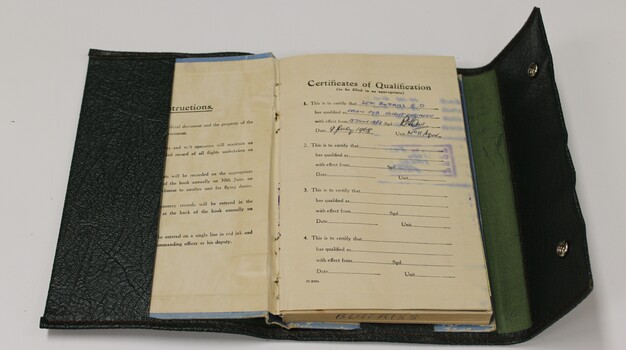 Green folder with Qualification Certificate for flight.