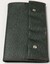 Green folder with studs to fasten qualification certificates for flight.