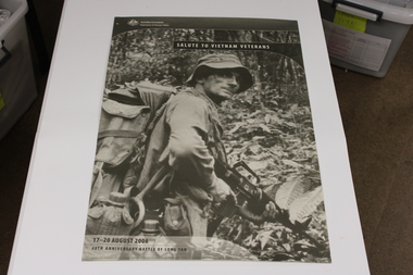 A sepia poster of a soldier carrying a rifle with the title "Salute to Vietnam".