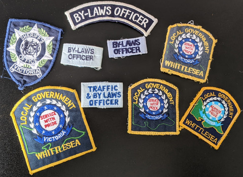 9 cloth badges or patches worn on the uniform of enforcement officers