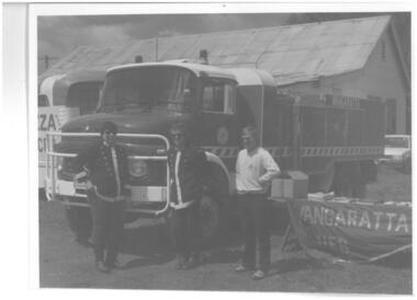 Photograph of Fire truck and 3 members