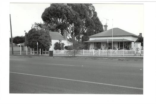 Former Middleton's Hardware shop and ironmongery visible behind tree, former separate weatherboard residence featured. Warrenheip street visible in foreground. 