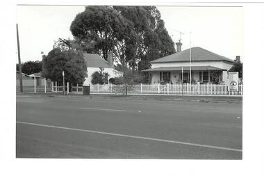 Former Middleton's Hardware shop and ironmongery visible behind tree, former separate weatherboard residence featured. Warrenheip street visible in foreground. 