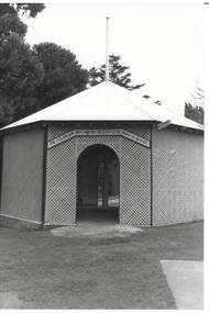 Octagonal rotunda, wooden lattice walls, iron roof with flagpole, arched entrance centre, looking into rotunda