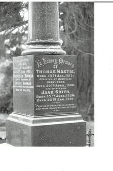 pair of photos, one B/W, one colour, of polished granite column and engraved plinth