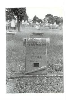 B/W photo, Buninyong Cemetery, carved carved and engraved Marble headstone, scroll at bottom, rounded top,  for Thomas Hiscock and his wife Phoebe. More graves in background.