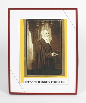3/4 length portrait, side view of Reverend Thomas Hastie, wearing formal clerical attire, holding a religious book 