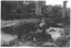 Mt Mercer Junction Bridge. A woman, Elsie Gibson, is sitting on the river bank with the bridge in the background.