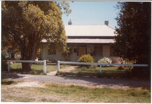 Victorian era weatherboard house with metal roof and verandah, low front fence.