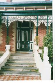 Close up of the front door of "Mount Helen" showing detail of verandah lace work, brickwork surrounding door and front steps.