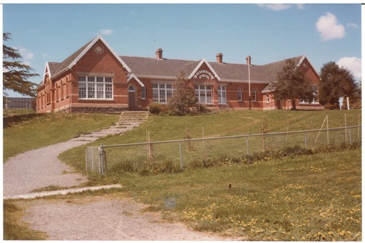 Buninyong State School from below, brick, three gables, slate roof, white wooden multi-paned windows.