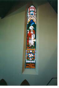 Tall, narrow, gothic stained glass window, depicting "The Light of the World."