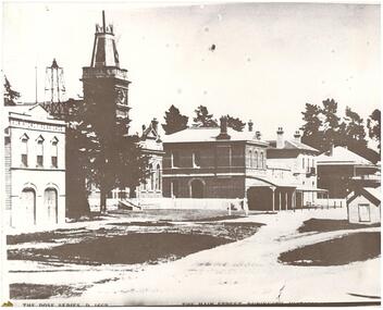 Street scene, fire station, Town Hall with clock-tower, two story brick shops, two story hotel with verandah.
