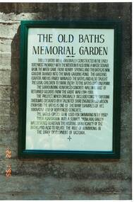 Colour photograph of Plaque on wall of old Buninyong Swimming Pool in Buninyong Botanical Gardens giving history of the Old Baths