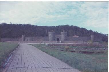 View of Kryal Castle showing main entrance flanked by towers. The castellated wall and Mt Warrenheip is in the background