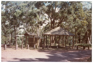 Colour photograph of Mt Buninyong picnic area showing water tower, shelter, seating, roofed display board and barrier posts