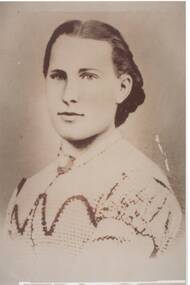 Head and shoulders portrait young lady, Victorian dress, embroidered, brooch at neck, dark hair.