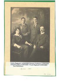 Studio family portrait, mother seated left, father seated right, adult sons standing behind, son on left with glasses and in military uniform.