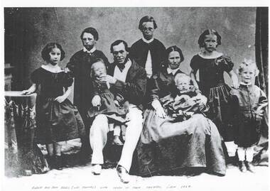 Studio family portrait, Victorian era, parents seated centre, each with infant on their lap, two older children standing either side, and eldest son standing behind.