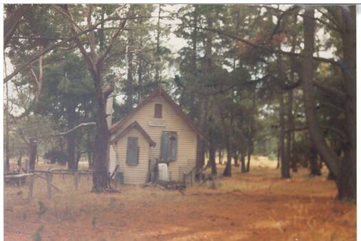 Photograph depicts a typical wooden school building