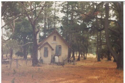 Photograph depicts a typical wooden school building