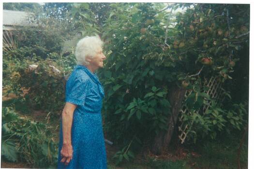 May Coxall in her garden at Scotsburn admiring her apple tree