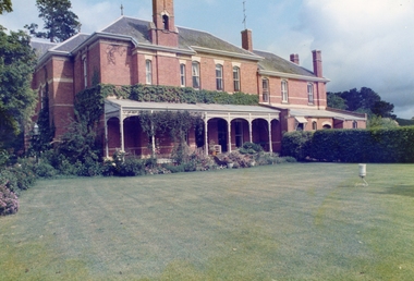 Colour photograph of Mount Buninyong Homestead, showing front of house, garden and croquet lawn in 1991.