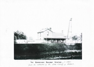 Black and white image of the stone, double storey building of the Buninyong Station (Yendon) clearly showing the platform and signal tower and the sign "Buninyong"