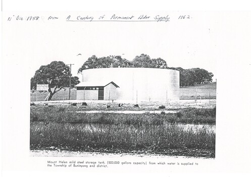 Black and white photograph storage tank at Mount Helen, taken at its opening in 1958 for Buninyong Water Trust showing a single mild steel storage tank (500,000 gallon capacity) surrounding mesh fencing and small pumping shed