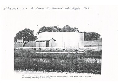 Black and white photograph storage tank at Mount Helen, taken at its opening in 1958 for Buninyong Water Trust showing a single mild steel storage tank (500,000 gallon capacity) surrounding mesh fencing and small pumping shed